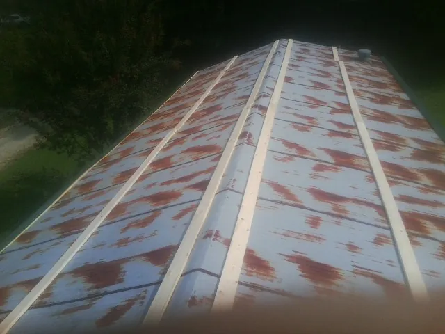 Rusted metal roof panels with new wood purlins before replacement — Storm Damage Roof Repair in Pontotoc by Roofing Brothers
